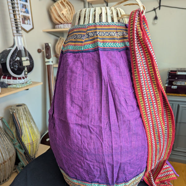 A magenta mridanga cover wrapped around a mridanga